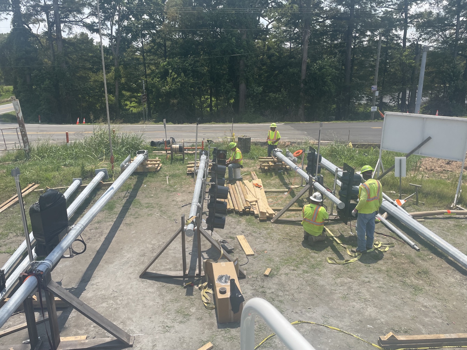 InLine crews assembling traffic signal mast arms and signal heads