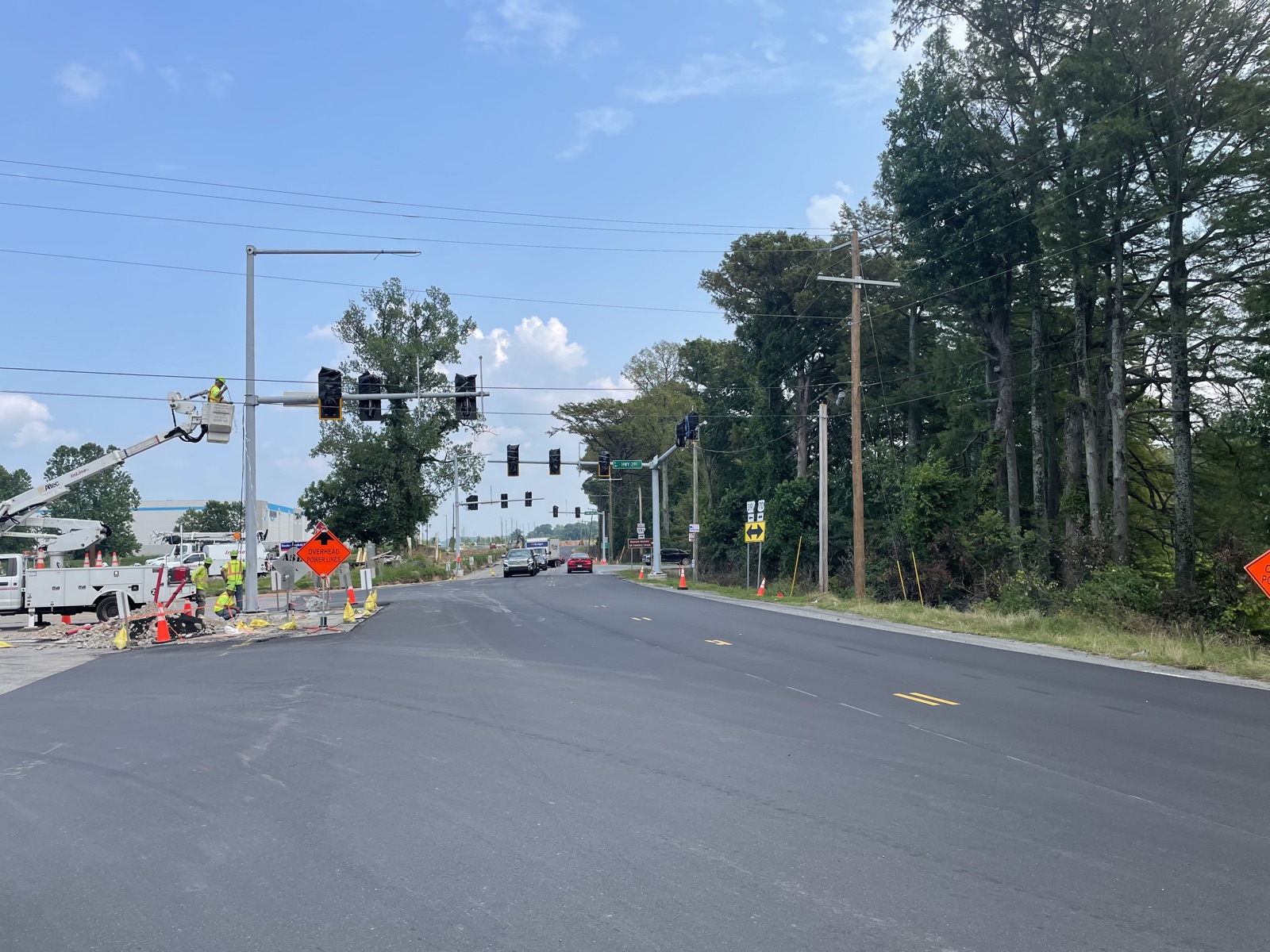 InLine bucket truck crew installing traffic signal equipment over the roadway