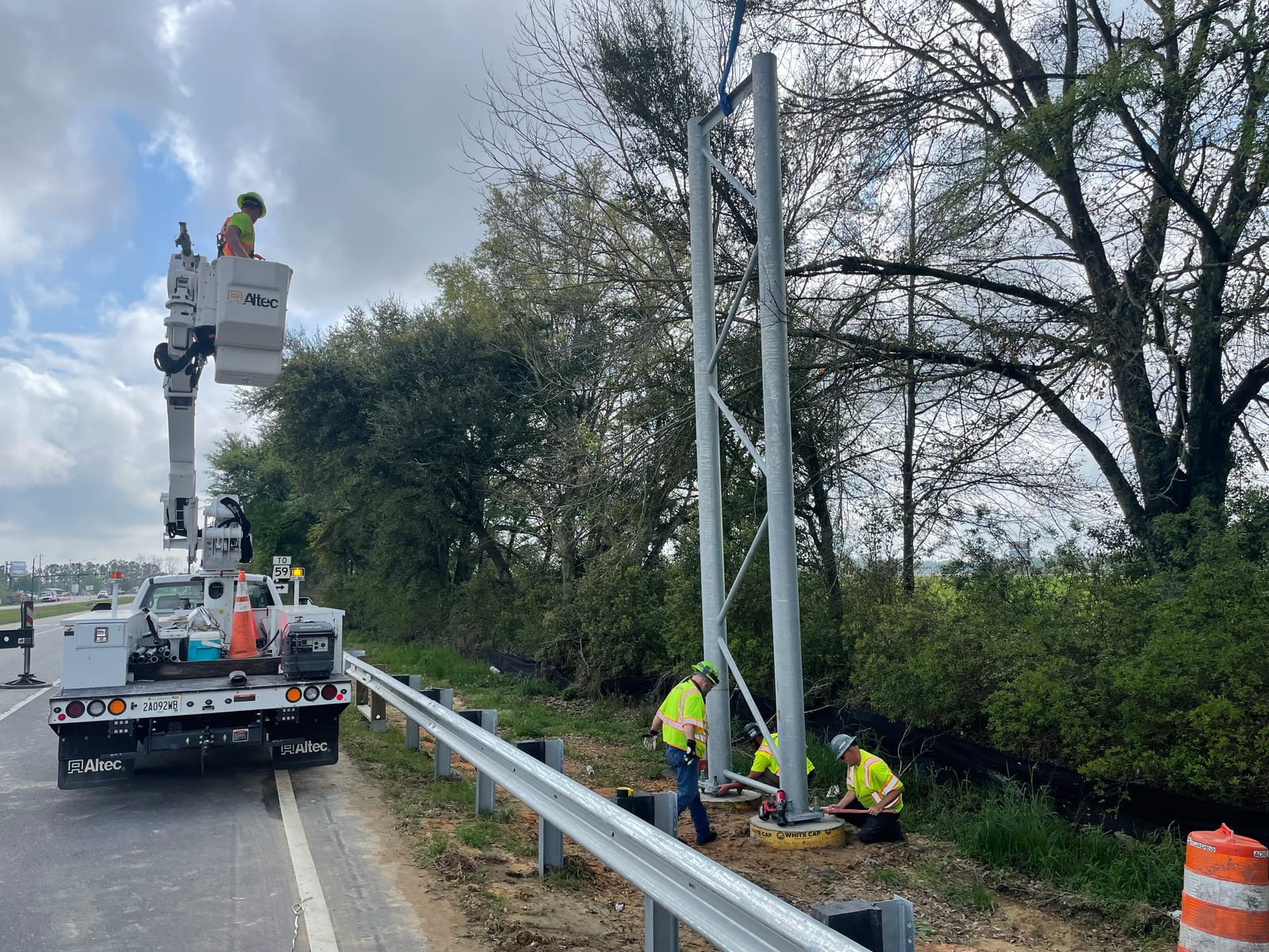 InLine crews securing a sign bridge support tower beside the Baldwin Beach Express