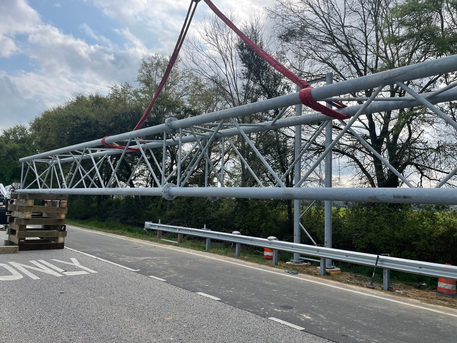 Galvanized Baldwin Beach Express sign bridge truss rigged for installation