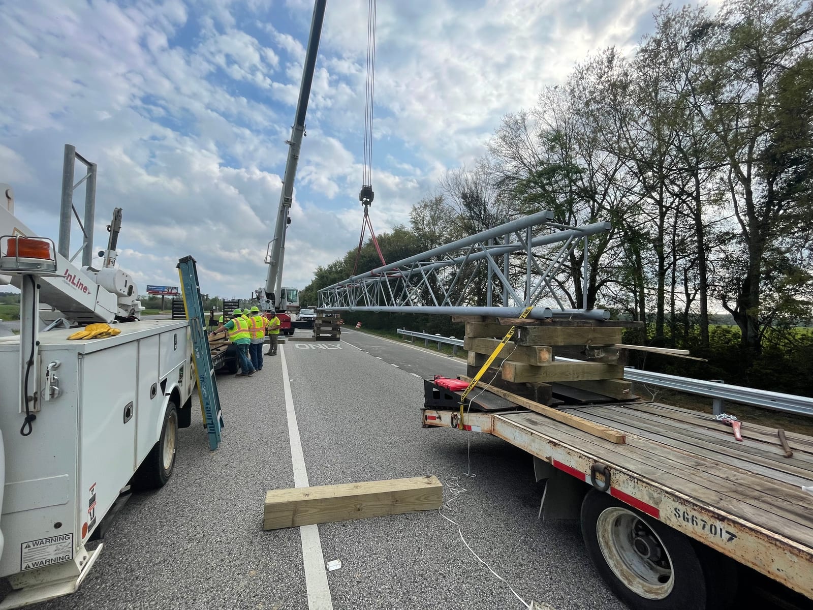 InLine crews staging the sign bridge truss on cribbing before the lift