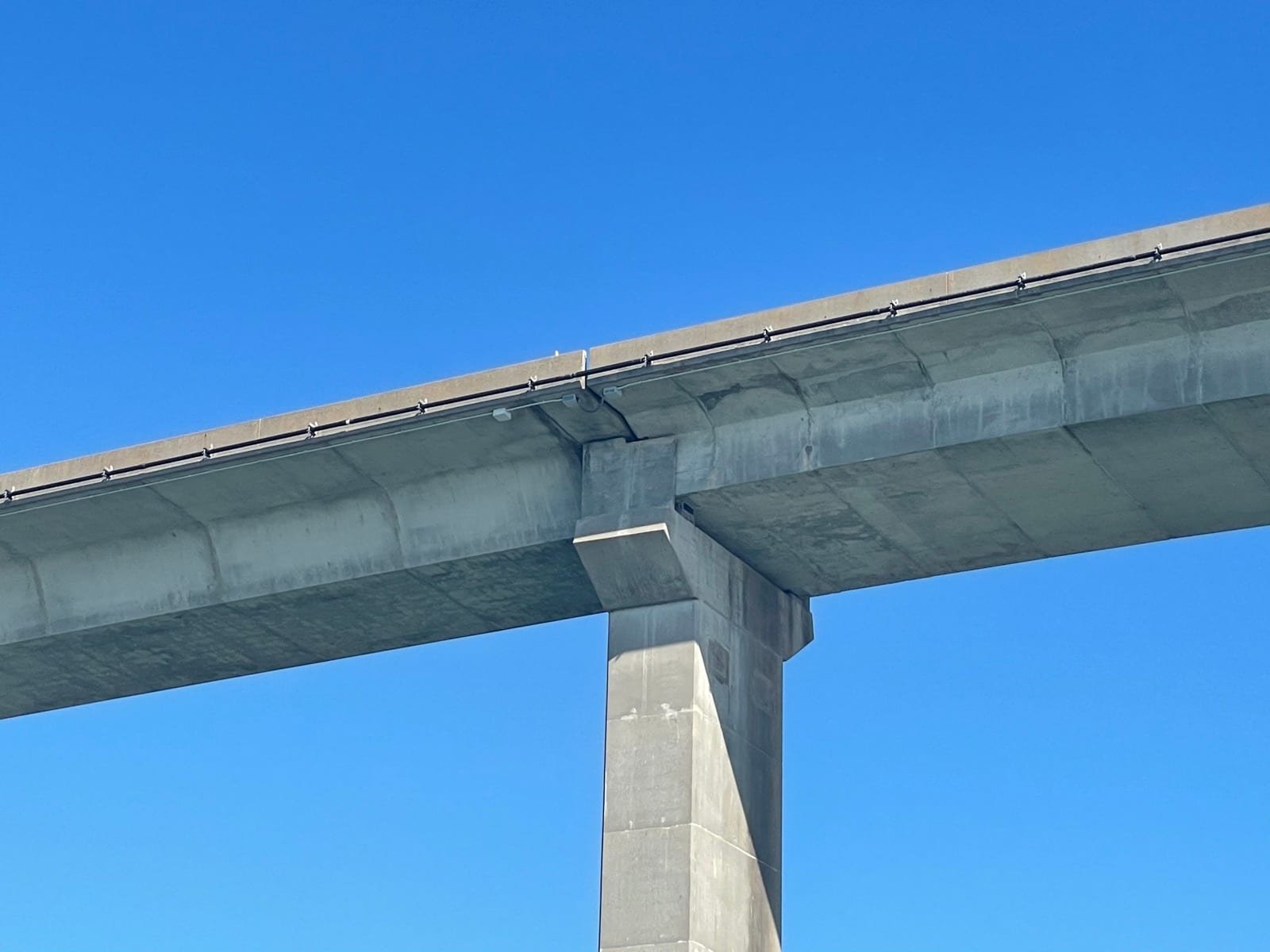 Structure-mounted conduit routed along the Dauphin Island Bridge