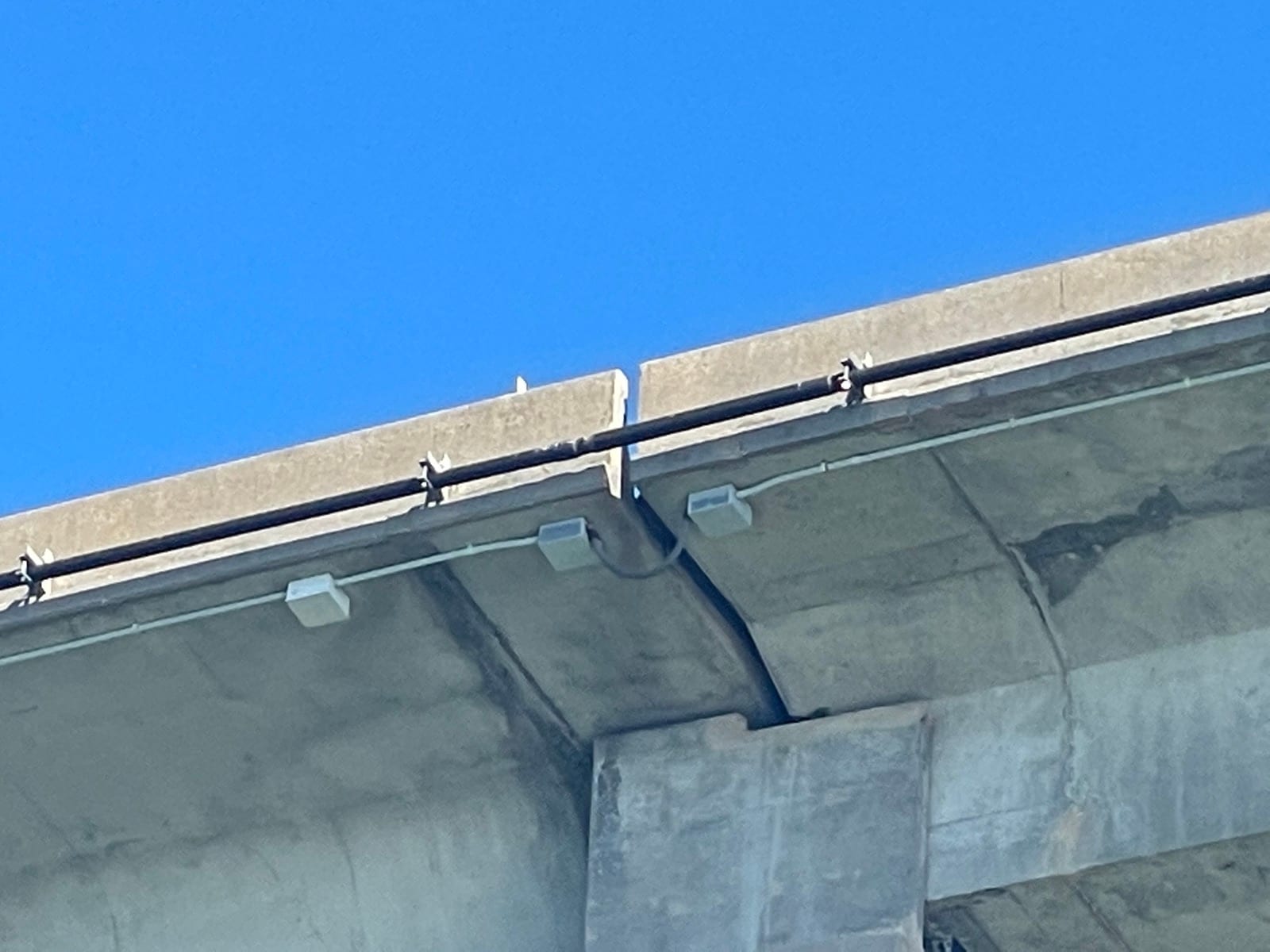 Conduit and network fixtures at a bridge expansion joint