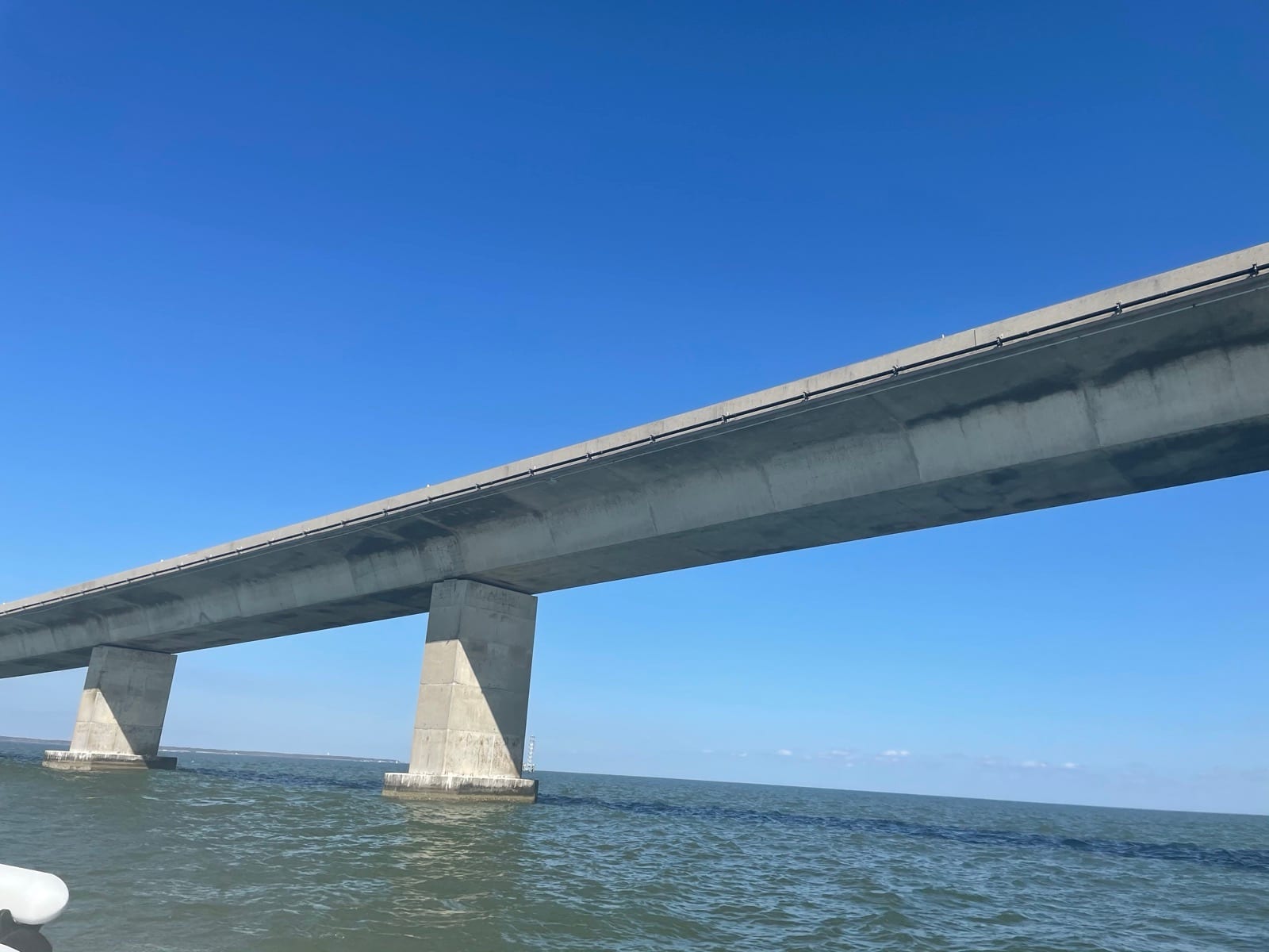 Long structure-mounted conduit run along the bridge span