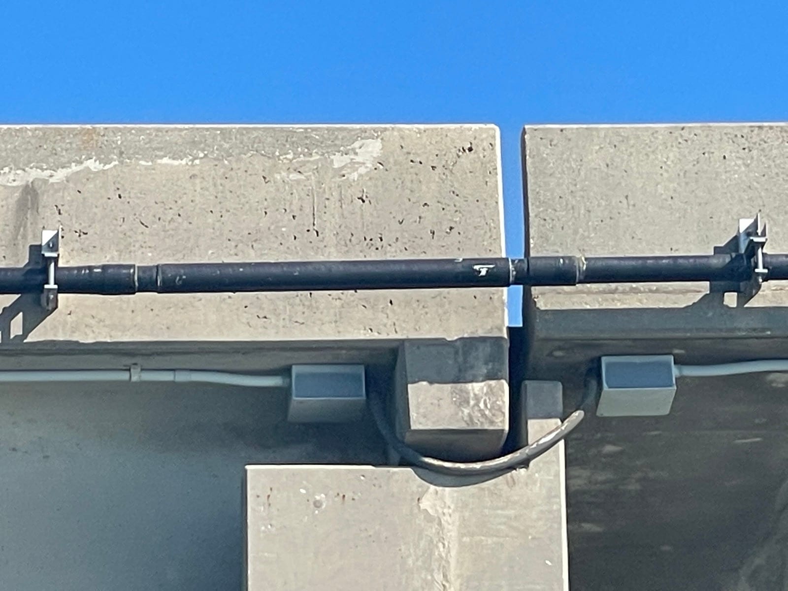 Close view of conduit supports and expansion-joint loop