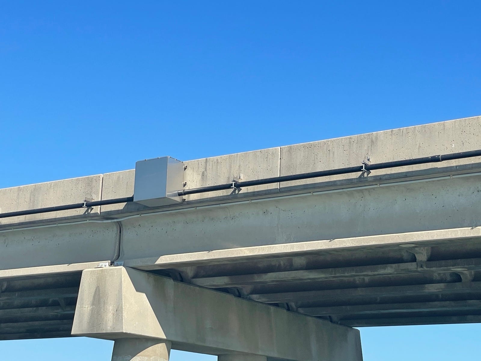 Stainless network enclosure and conduit mounted on the bridge