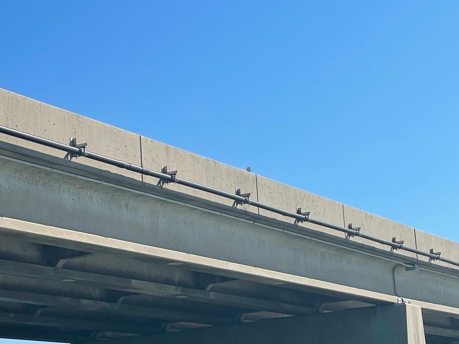 Conduit support brackets installed along the bridge corridor