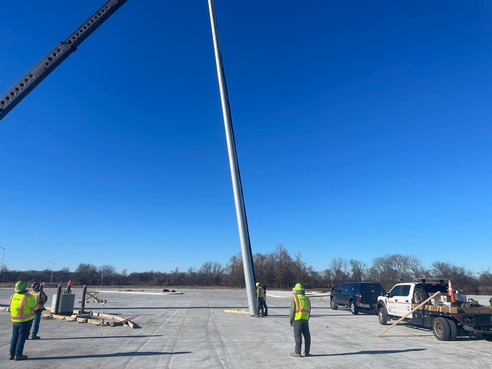 InLine crews guiding the high-mast pole during installation in West Memphis