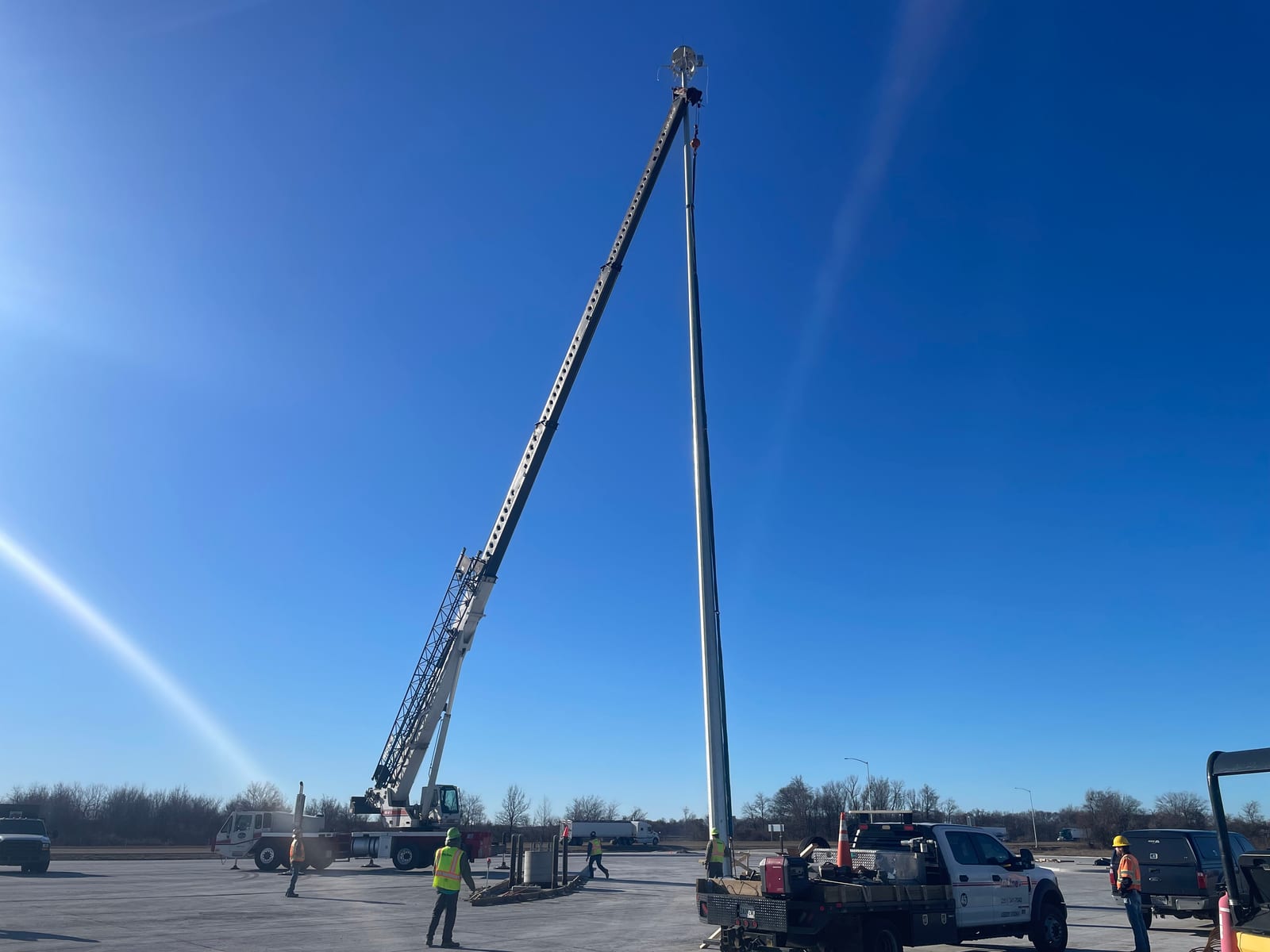 Crane and InLine crews setting a high-mast lighting pole at the West Memphis truck parking facility