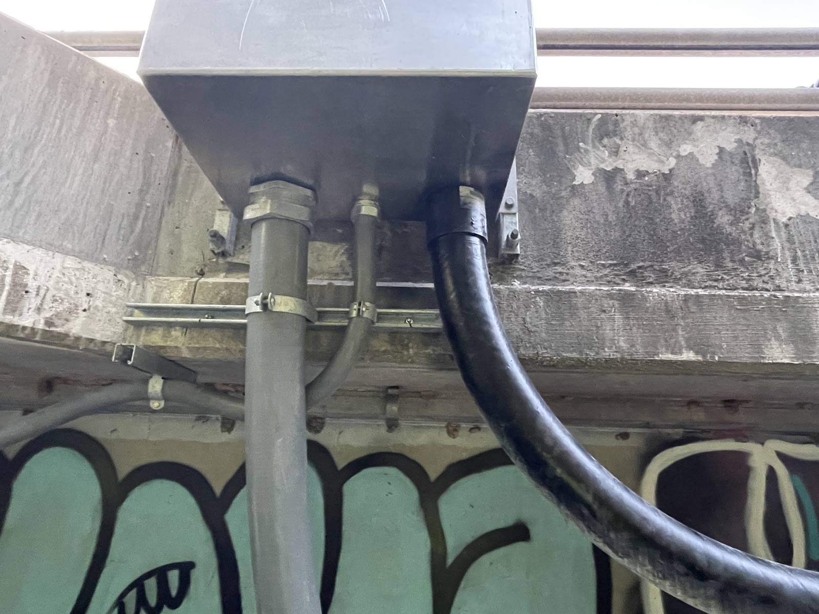 Bridge conduit and cable entry detail at a junction enclosure