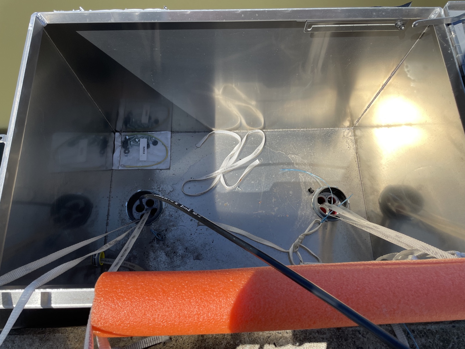 Fiber and cable routing inside a bridge-mounted enclosure