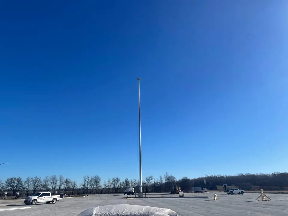 Completed high-mast lighting pole standing over the I-40 truck parking area